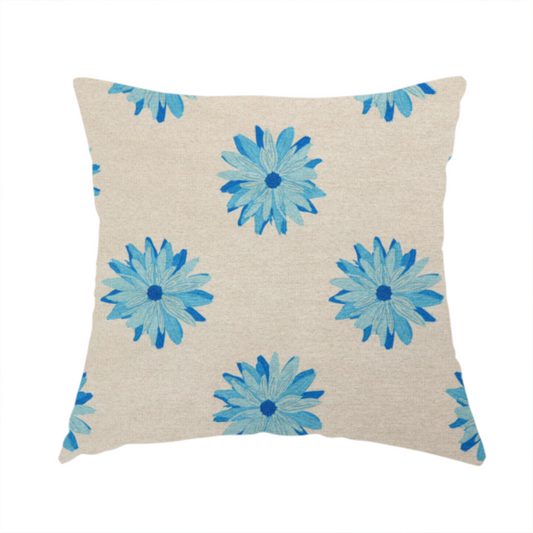 The fabric used to create this handmade cushion is a fabric pattern featuring repeating bright blue daisy-like flowers set against a neutral beige woven background.   