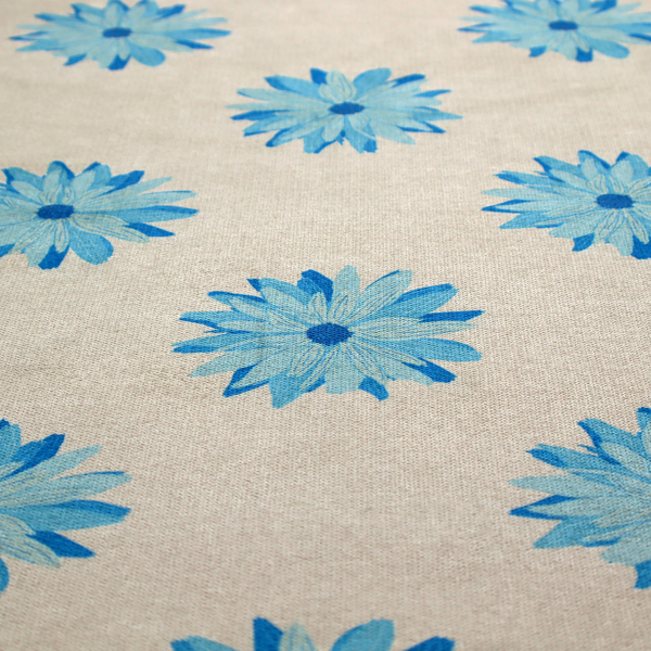 Fabric pattern featuring repeating bright blue daisy-like flowers set against a neutral beige woven background.   