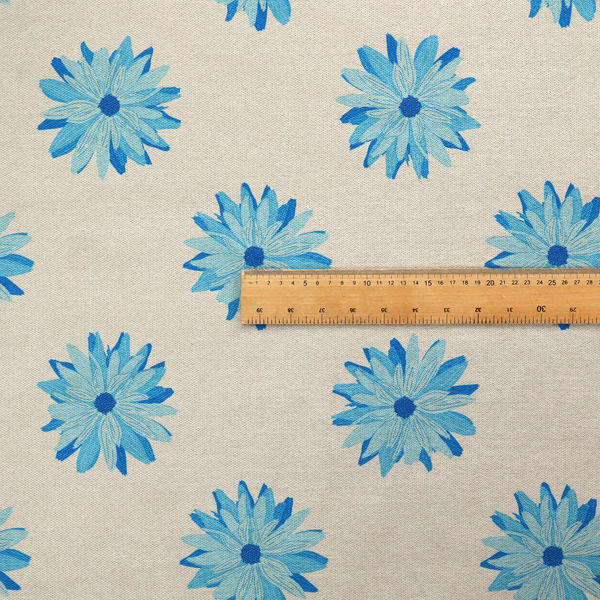 Fabric pattern featuring repeating bright blue daisy-like flowers set against a neutral beige woven background.   