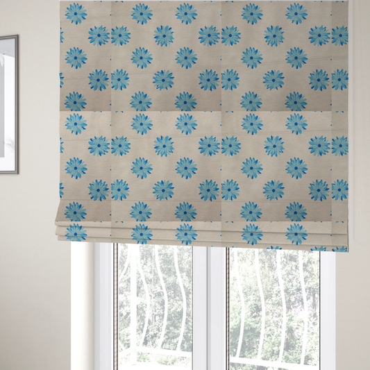 The fabric used to create these Roman blinds is a fabric pattern featuring repeating bright blue daisy-like flowers set against a neutral beige woven background.   
