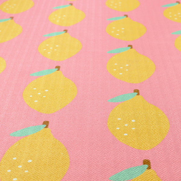 Pink fabric with a repeating pattern of yellow lemons, light green leaves, and small white dots.