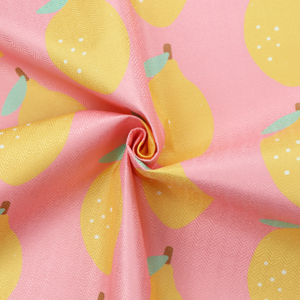 Pink fabric with a repeating pattern of yellow lemons, light green leaves, and small white dots.