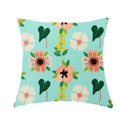 The fabric used to create this handmade cushion is a whimsical floral fabric featuring peach and cream flowers, yellow vining stems, and dark green heart-shaped leaves on a light mint turquoise background.   