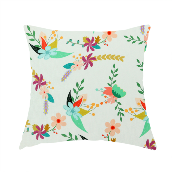 The fabric used to create this handmade cushion is a playful floral fabric featuring scattered colourful bouquets with light blue, coral, purple, and peach blossoms among green stems and mustard foliage on a off-white background.   