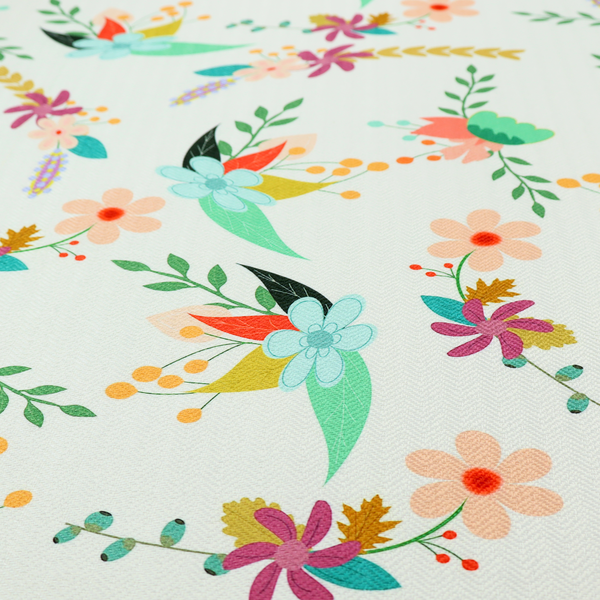 Playful floral fabric featuring scattered colourful bouquets with light blue, coral, purple, and peach blossoms among green stems and mustard foliage on a off-white background.   