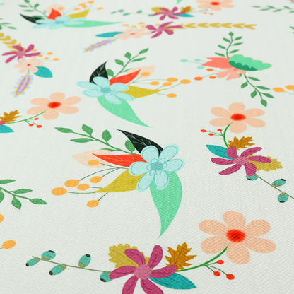 Playful floral fabric featuring scattered colourful bouquets with light blue, coral, purple, and peach blossoms among green stems and mustard foliage on a off-white background.   