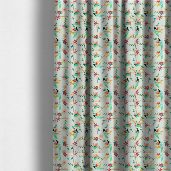 The fabric used to create these made-to-measure curtains is a playful floral fabric featuring scattered colourful bouquets with light blue, coral, purple, and peach blossoms among green stems and mustard foliage on a off-white background.   