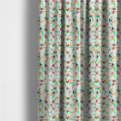The fabric used to create these made-to-measure curtains is a playful floral fabric featuring scattered colourful bouquets with light blue, coral, purple, and peach blossoms among green stems and mustard foliage on a off-white background.   