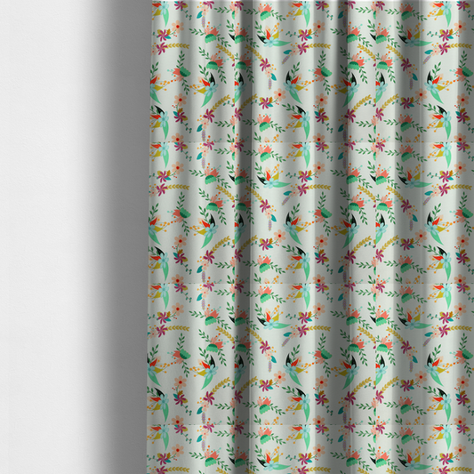 The fabric used to create these made-to-measure curtains is a playful floral fabric featuring scattered colourful bouquets with light blue, coral, purple, and peach blossoms among green stems and mustard foliage on a off-white background.   