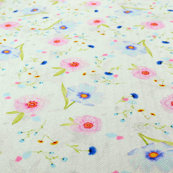 Delicate watercolour floral fabric featuring soft pink poppies, pale blue cosmos, and tiny cornflower buds on a white herringbone-textured background.