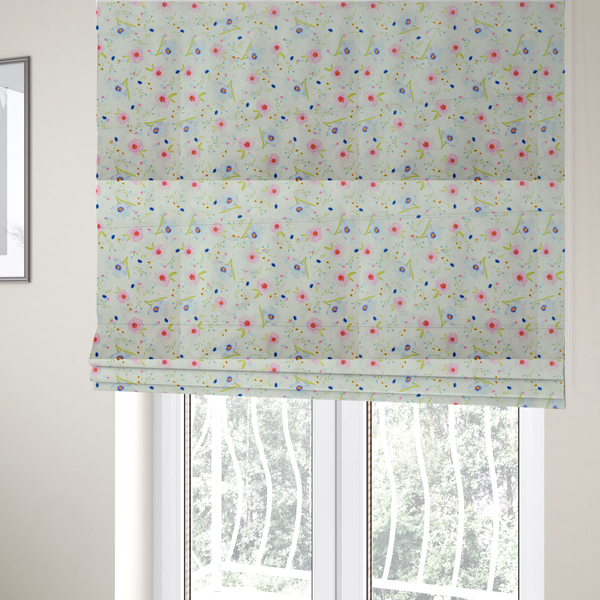 The fabric used to create these Roman blinds is a delicate watercolour floral fabric featuring soft pink poppies, pale blue cosmos, and tiny cornflower buds on a white herringbone-textured background.