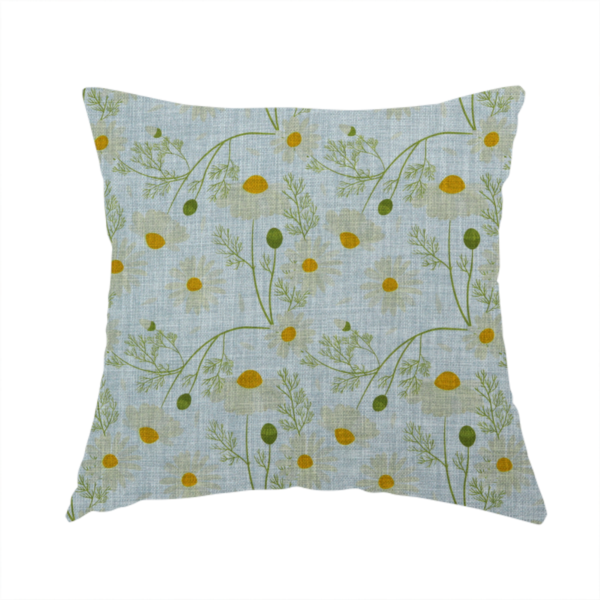 The fabric used to create this handmade cushion is a light blue fabric with a repeating botanical chamomile flower and green foliage pattern