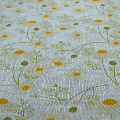 Light blue fabric with a repeating botanical chamomile flower and green foliage pattern
