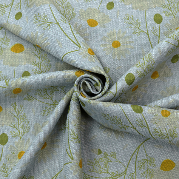 Light blue fabric with a repeating botanical chamomile flower and green foliage pattern