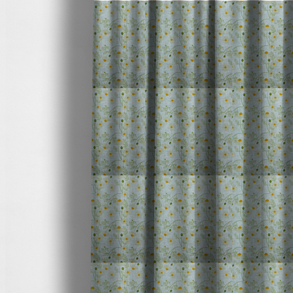 The fabric used to create these made-to-measure curtains is a light blue fabric with a repeating botanical chamomile flower and green foliage pattern