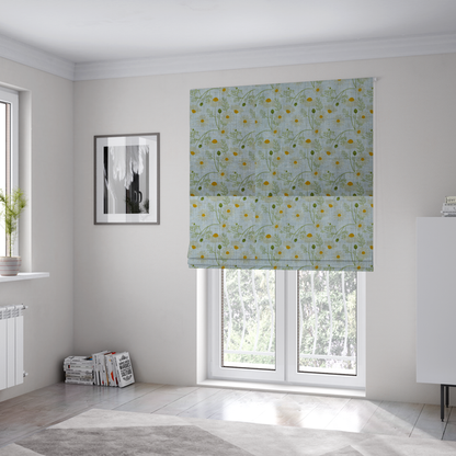 The fabric used to create these Roman blinds is a light blue fabric with a repeating botanical chamomile flower and green foliage pattern