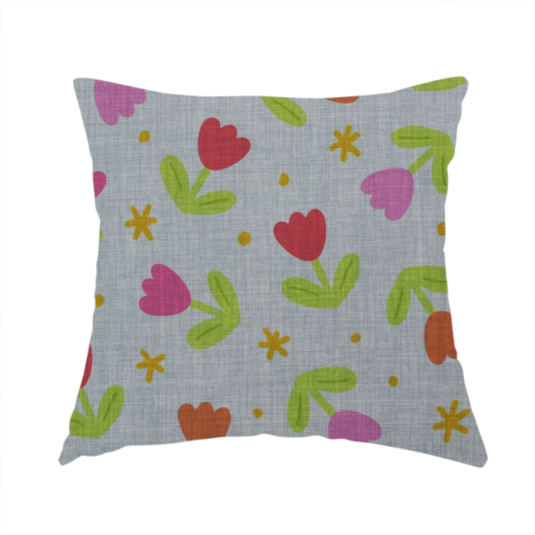 The fabric used to create this handmade cushion is a muted greyish-blue fabric with a whimsical pattern of colourful tulips and small gold accents.