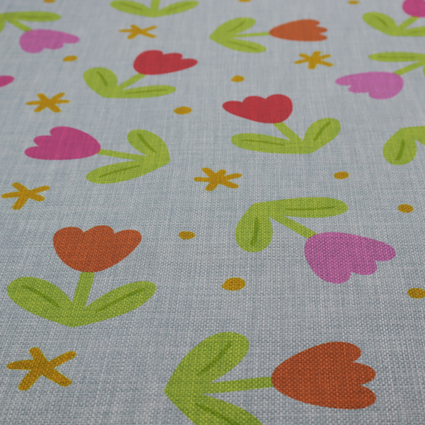 Muted greyish-blue fabric with a whimsical pattern of colourful tulips and small gold accents.
