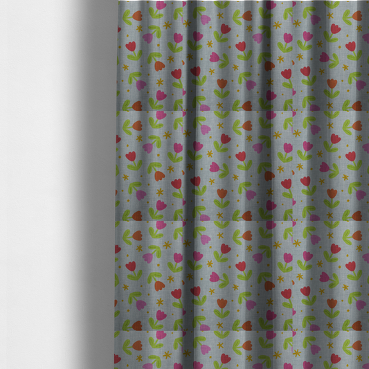 The fabric used to create these made-to-measure curtains is a muted greyish-blue fabric with a whimsical pattern of colourful tulips and small gold accents.
