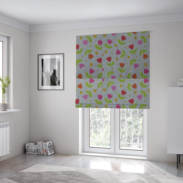 The fabric used to create these Roman blinds is a muted greyish-blue fabric with a whimsical pattern of colourful tulips and small gold accents.