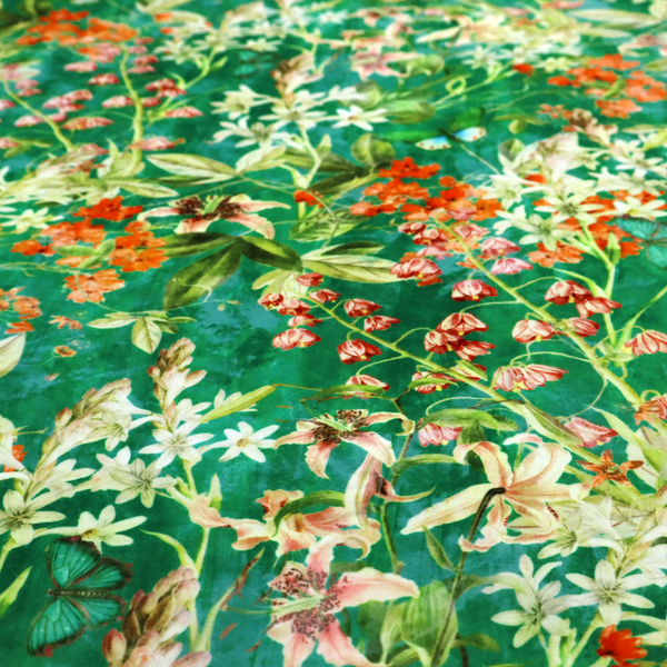 A dense, layered display of vibrant orange blossoms, delicate white jasmine-like star flowers, pink lily variations, and hanging bell-shaped blooms nestled among rich green foliage.