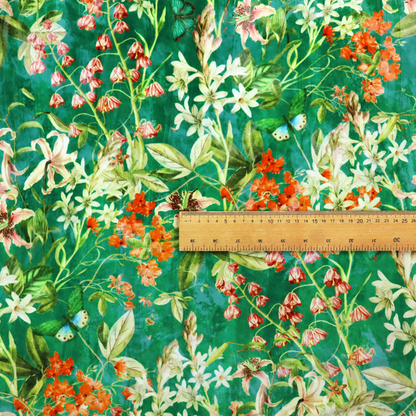 A dense, layered display of vibrant orange blossoms, delicate white jasmine-like star flowers, pink lily variations, and hanging bell-shaped blooms nestled among rich green foliage.