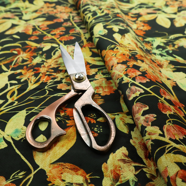 A black fabric with an all-over botanical print of golden-yellow leaves, orange flowers, and subtle small butterflies.