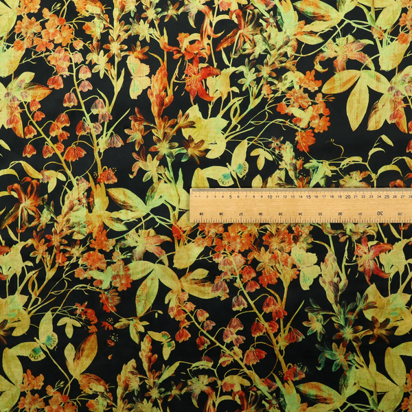 A black fabric with an all-over botanical print of golden-yellow leaves, orange flowers, and subtle small butterflies.