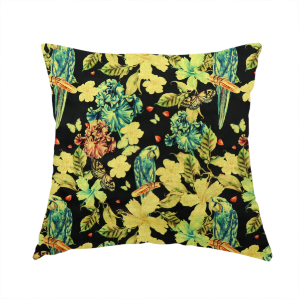 The fabric used to create this handmade cushion is a repeating fabric pattern featuring blue and green parrots, butterflies, and large tropical flowers on a black background.