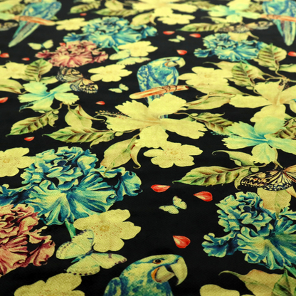 A repeating fabric pattern featuring blue and green parrots, butterflies, and large tropical flowers on a black background.
