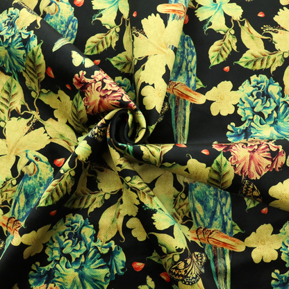 A repeating fabric pattern featuring blue and green parrots, butterflies, and large tropical flowers on a black background.