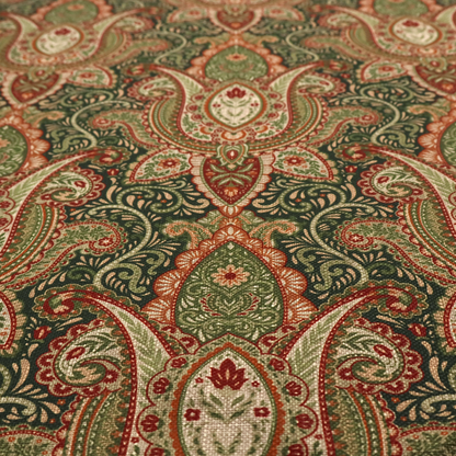 A repeating ornate paisley and damask medallion fabric pattern in terracotta, sage green, and cream on a forest green background.