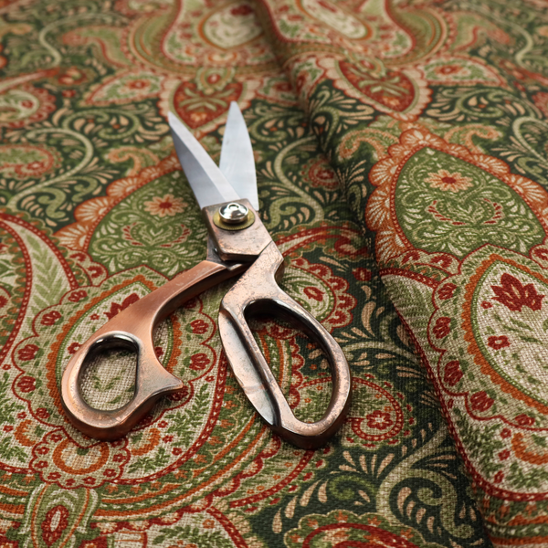 A repeating ornate paisley and damask medallion fabric pattern in terracotta, sage green, and cream on a forest green background.