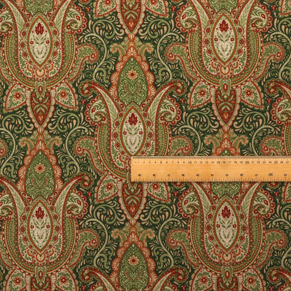 A repeating ornate paisley and damask medallion fabric pattern in terracotta, sage green, and cream on a forest green background.
