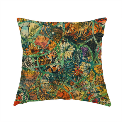The fabric used to create this handmade cushion is an abstract mosaic fabric pattern with stained glass-style botanical and floral illustrations in emerald green, orange, and gold tones.