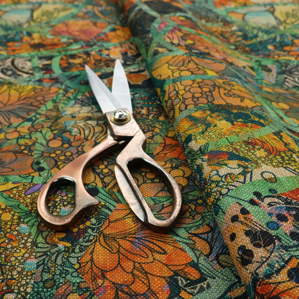 An abstract mosaic fabric pattern with stained glass-style botanical and floral illustrations in emerald green, orange, and gold tones.