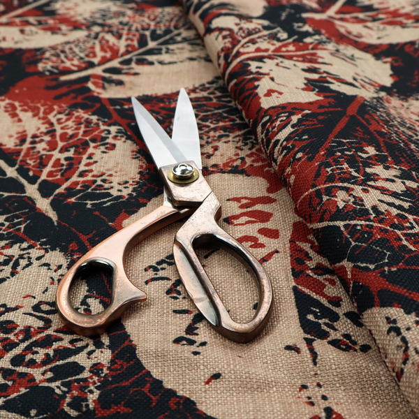 An abstract skeleton leaf fabric pattern featuring bold botanical leaf motifs in terracotta red, natural beige, and black.