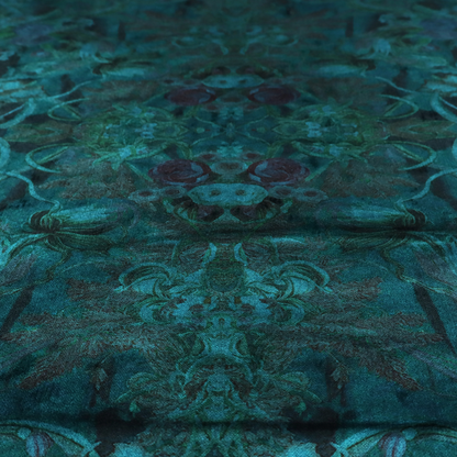 A symmetrical, damask-style botanical fabric pattern in deep teal and turquoise tones, featuring an intricate mirror-image design of large sunflowers, roses, swirling vines, and leafy foliage against a dark, textured background.