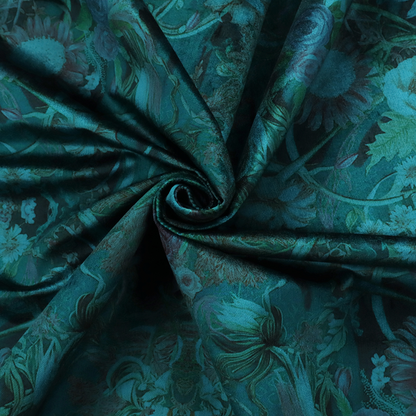 A symmetrical, damask-style botanical fabric pattern in deep teal and turquoise tones, featuring an intricate mirror-image design of large sunflowers, roses, swirling vines, and leafy foliage against a dark, textured background.