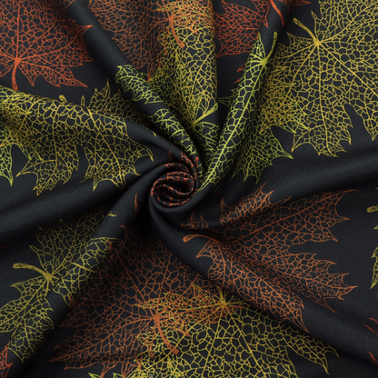 An autumn botanical fabric pattern featuring detailed skeleton maple leaf outlines in rust red, olive green, and gold on a black background.