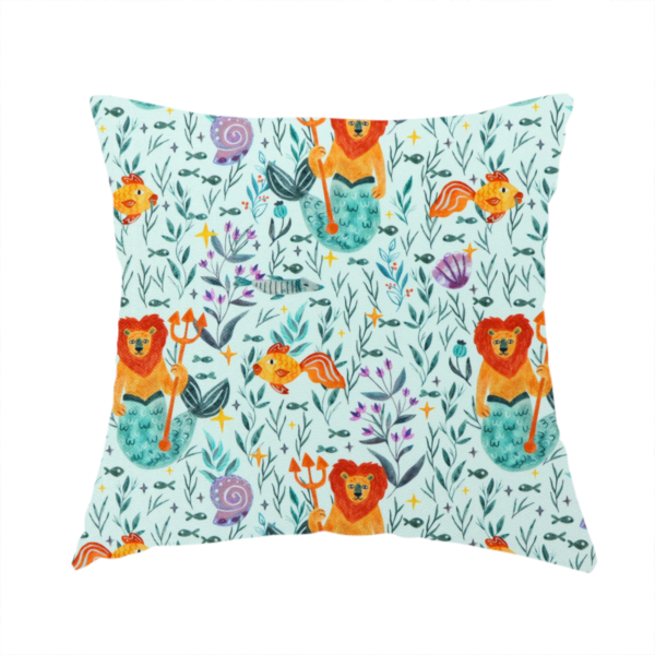 The fabric used to create this handmade cushion is a whimsical fabric pattern featuring orange lion mermaids holding tridents surrounded by fish, sea shells, and ocean flora on a light aqua background.