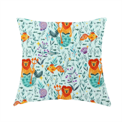 The fabric used to create this handmade cushion is a whimsical fabric pattern featuring orange lion mermaids holding tridents surrounded by fish, sea shells, and ocean flora on a light aqua background.