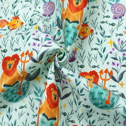 A whimsical fabric pattern featuring orange lion mermaids holding tridents surrounded by fish, sea shells, and ocean flora on a light aqua background.