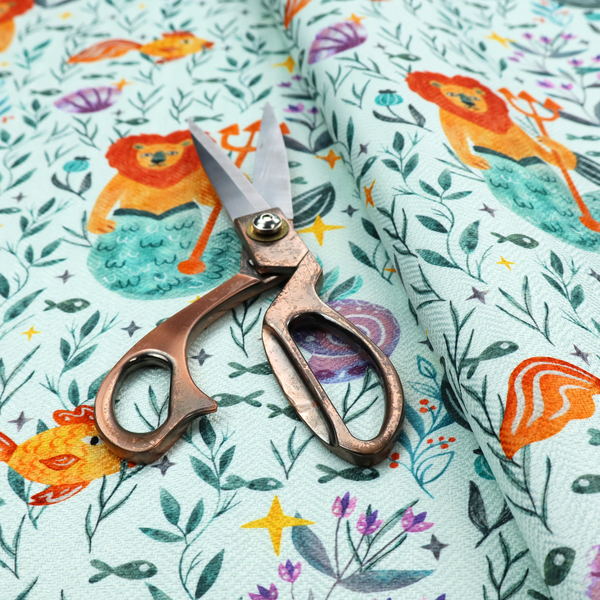 A whimsical fabric pattern featuring orange lion mermaids holding tridents surrounded by fish, sea shells, and ocean flora on a light aqua background.