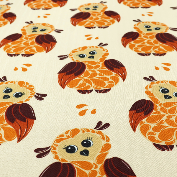 A repeating fabric pattern featuring illustrated owls with paisley-patterned bodies in warm orange, brown, and ochre on a cream background.