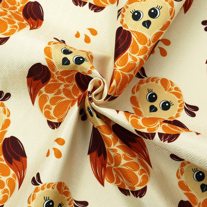 A repeating fabric pattern featuring illustrated owls with paisley-patterned bodies in warm orange, brown, and ochre on a cream background.