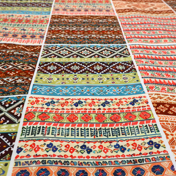 Vibrant multi-coloured tribal patchwork fabric featuring geometric and Aztec folk patterns.