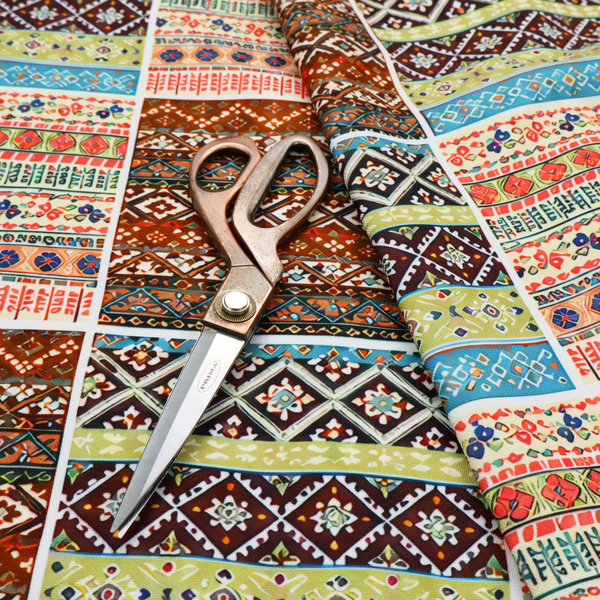 Vibrant multi-coloured tribal patchwork fabric featuring geometric and Aztec folk patterns.