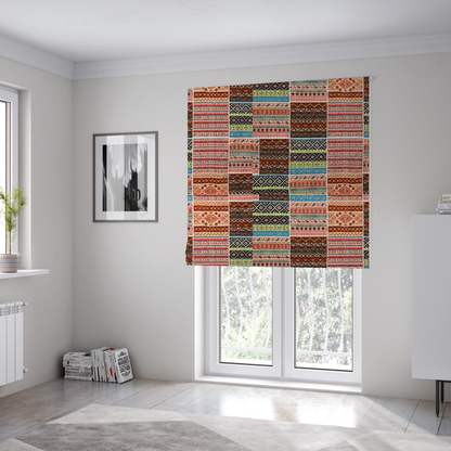 The fabric used to create these Roman blinds is a vibrant multi-coloured tribal patchwork fabric featuring geometric and Aztec folk patterns.