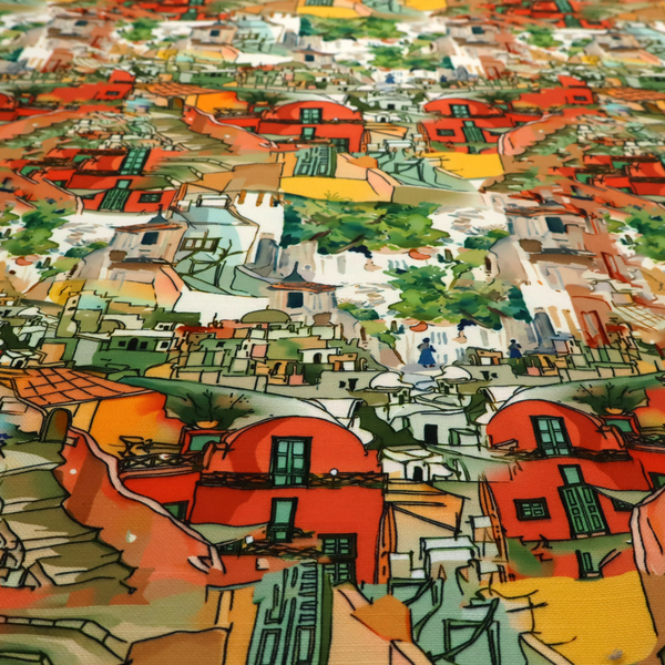 An illustrated fabric pattern featuring a Mediterranean hillside village with terracotta houses, green foliage, and ochre accents